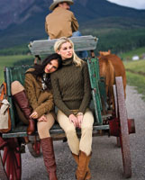 two women modeling fall fashions on the back of a wagon
