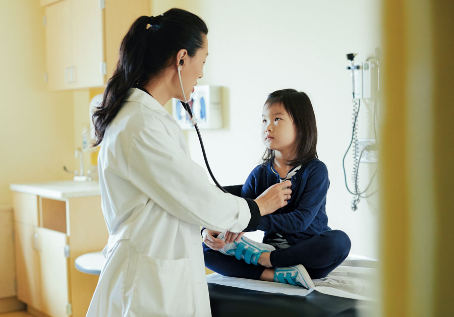 Dr. Judy Eckerle, head of University of Minnesota’s Adoption Medicine Clinic, treats a patient.