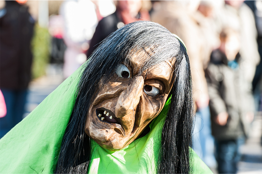 A person dressed as a goblin at a Halloween parade.