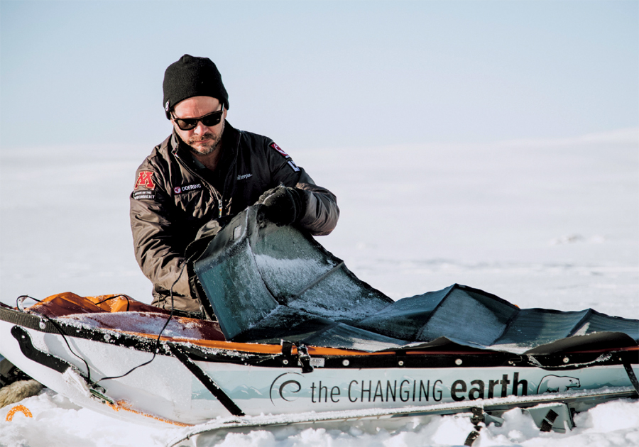 Aaron Doering attaching a solar panel to his pulk during his Changing Earth expedition in the highlands of Iceland in March 2017. The solar panel charges a portable battery tucked inside the pulk as Doering skis 8-10 hours between camps.
