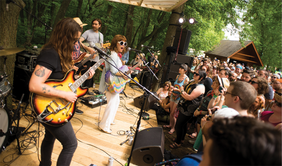 Jenny Lewis, front and center, performs with a band of white guys with guitars at Eaux Claires in 2017.