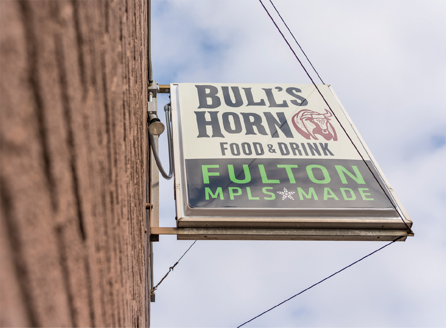 The exterior sign for Bull's Horn Food and Drink, a Minnesota dive bar.