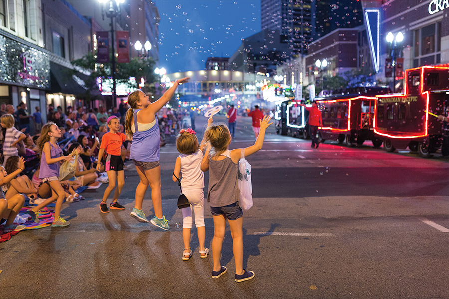 Kids cheering at the parade during the Aquatennial in Minneapolis.