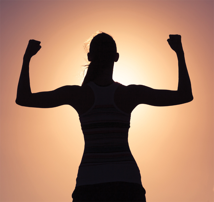 A silhouette of a woman flexing.