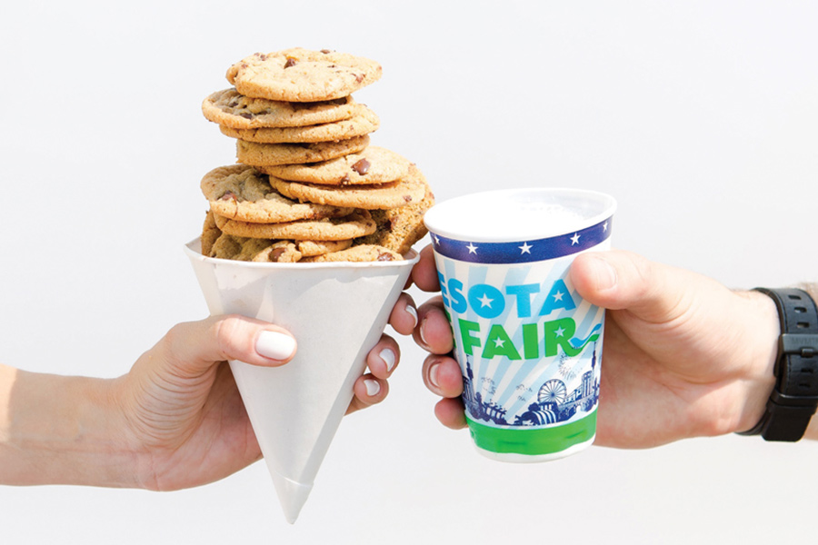 A cup of Sweet Martha's Cookies next to a glass of milk from the Minnesota State Fair.