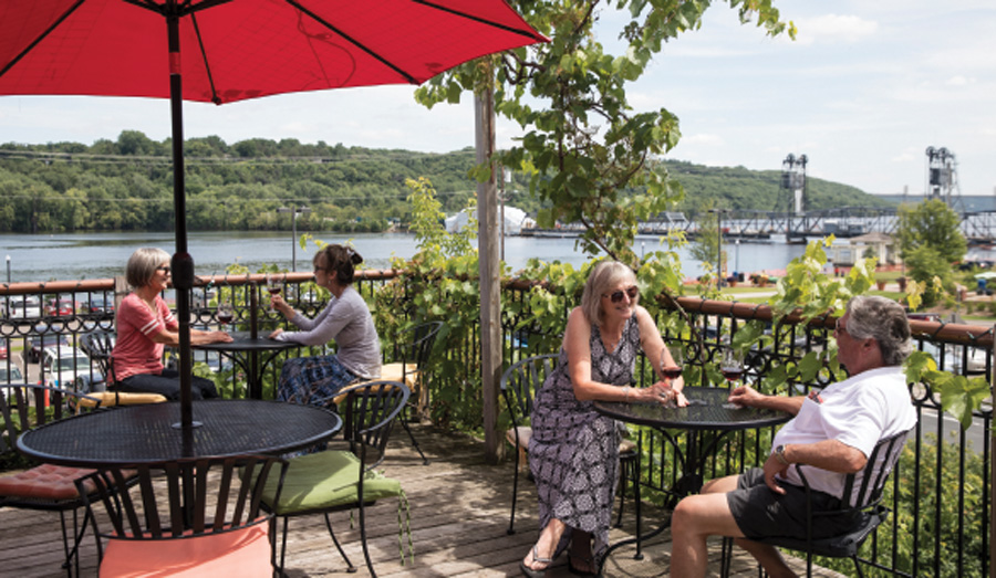 People sitting on the patio at Northern Vineyards Winery in Stillwater, Minnesota.