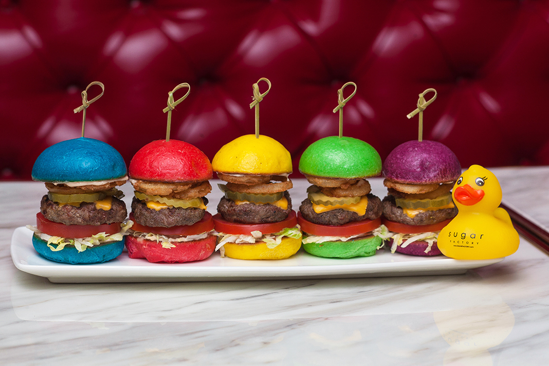 Burger sliders with vibrant colored buns, served with a branded rubber ducky.