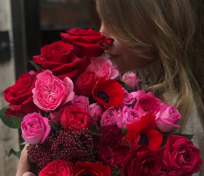 Woman holding a bunch of roses. Zika Fleisher/Unsplash