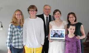 A family photo back at home with some Skyped-in members: Both Emma and Sam are excited to share the special day they planned with their siblings once things are safer.