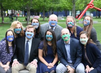 Audiology Concepts staff sitting outside wearing clear face masks