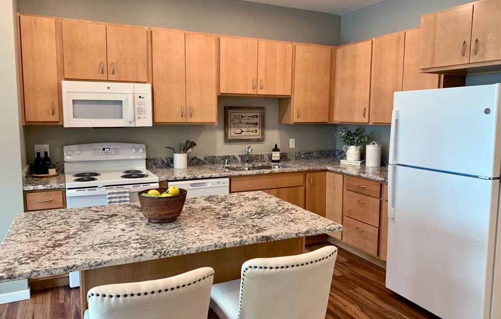 Island kitchens with granite countertops at Bren Road Station Apartments