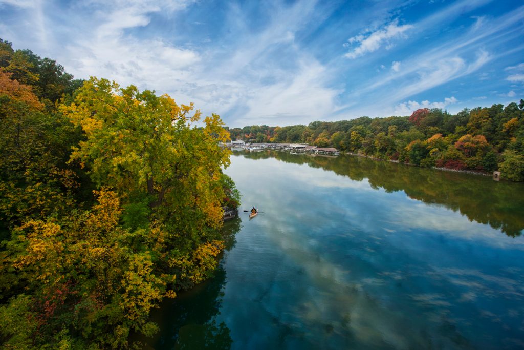 A person kayaking down a river in the Fox River