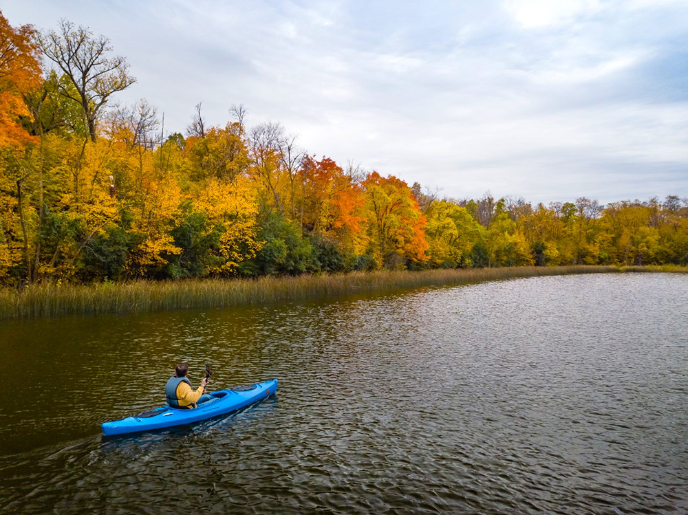 kayaker surrounded by fall minnesota colors