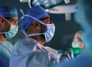 Transformative Care for Chronic Kidney Disease surgeon peering through scope