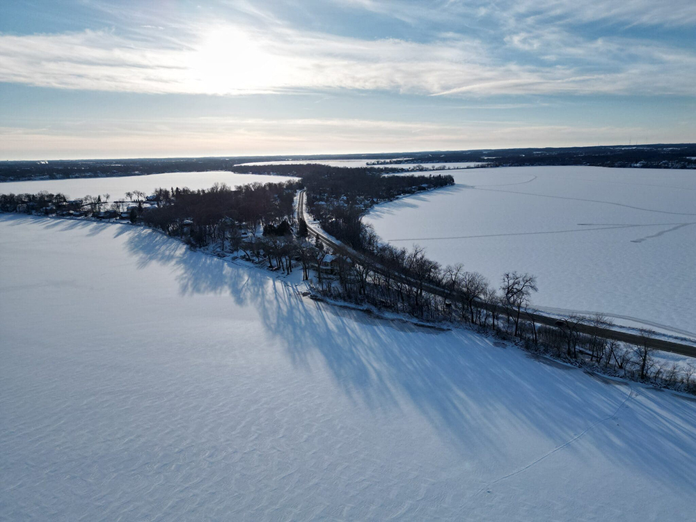 aerial shot of iced over lake
