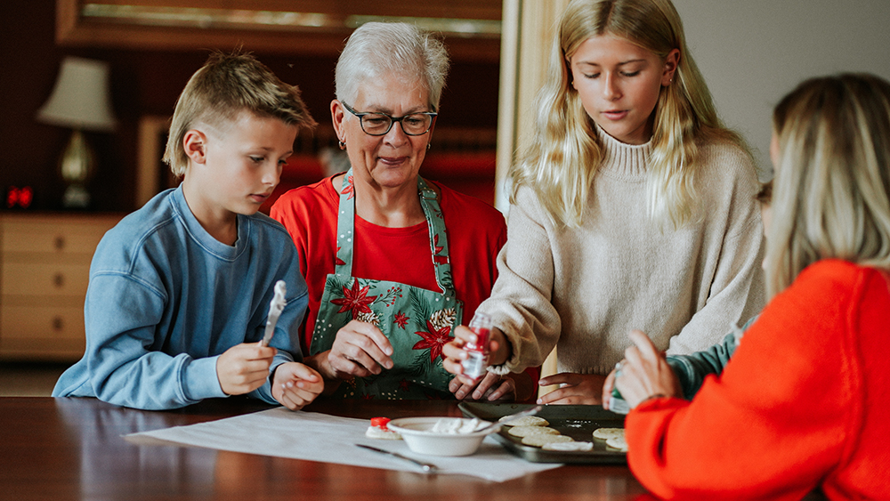 grandma and children making christmas cookies