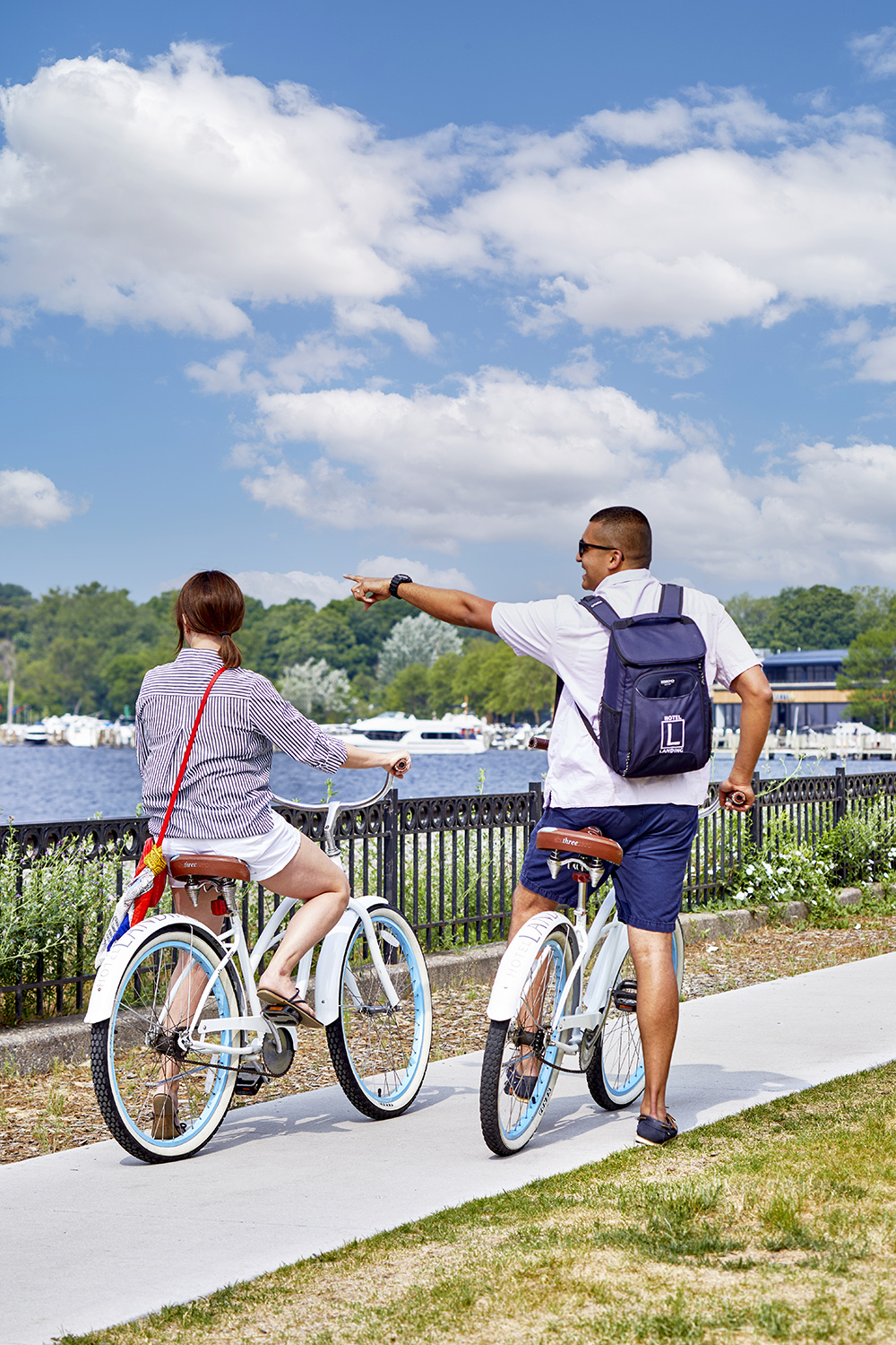 couple on bikes on boardwalk